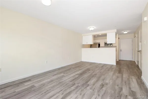 a view of a kitchen with a sink and a refrigerator