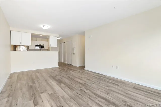 a view of a kitchen with a sink and a refrigerator