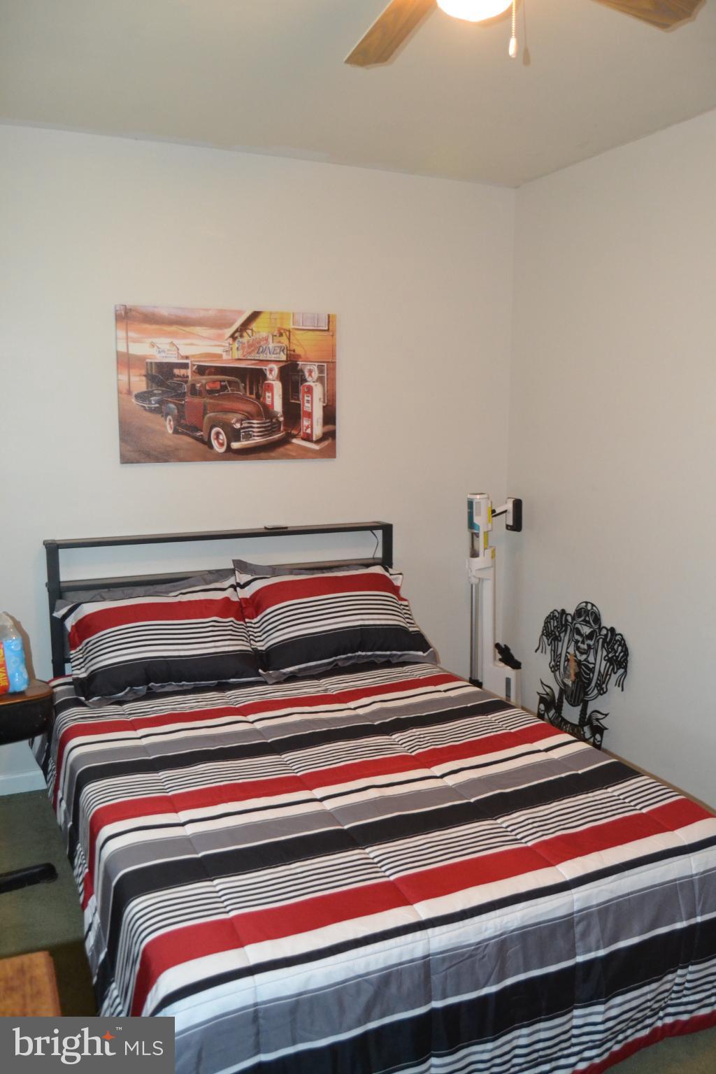 686 State Road West Grove, PA 19390 - Photo 15 of 43 a bedroom with a bed and a chandelier