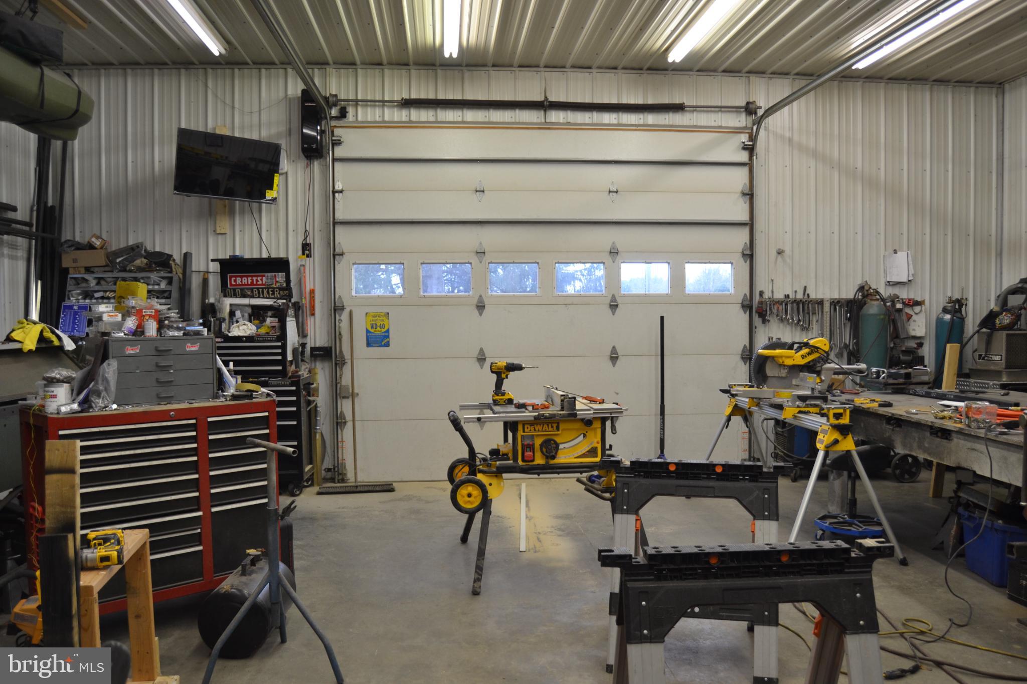 686 State Road West Grove, PA 19390 - Photo 27 of 43 a room with gym equipment and a flat screen tv