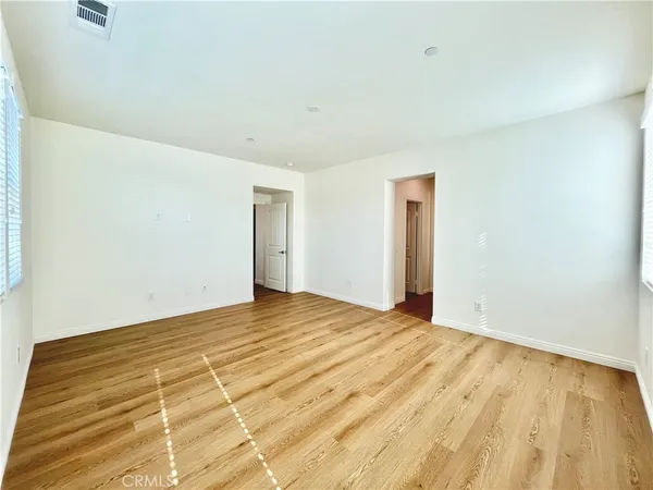 a view of a hallway with wooden floor