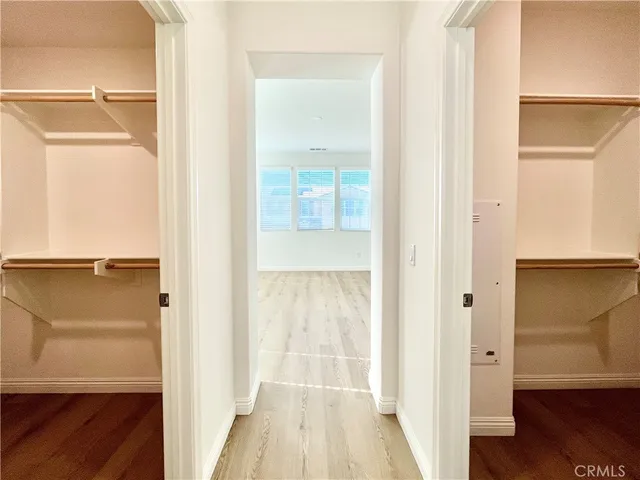a view of walk in closet with empty racks