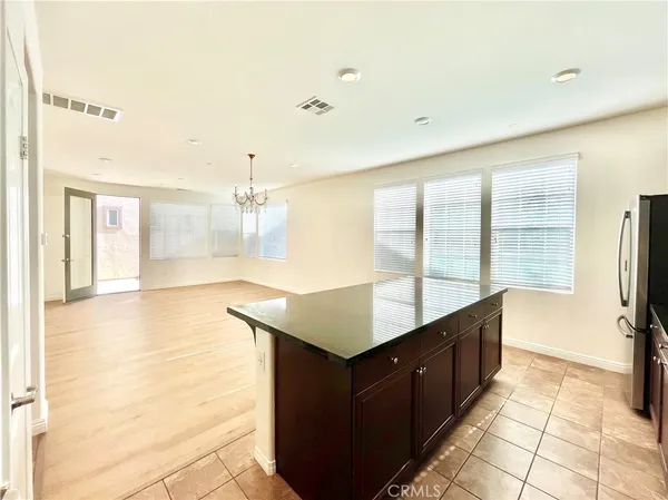 a kitchen with counter top space and windows
