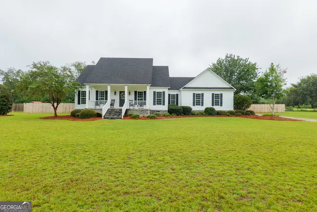 a front view of a building with lake view and a yard