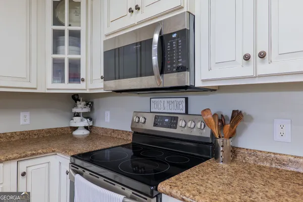 a kitchen with stainless steel appliances granite countertop a stove and a microwave