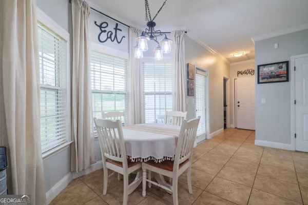 a view of a dining room with furniture window and outside view