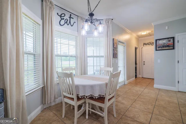 a view of a dining room with furniture window and outside view