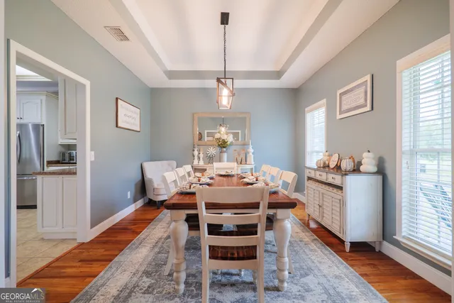 a view of a dining room with furniture window and wooden floor