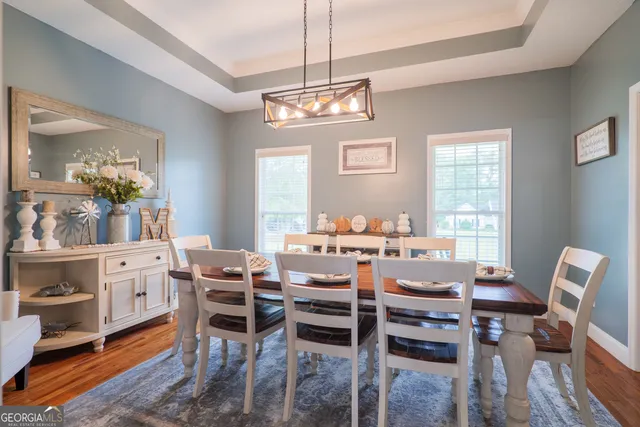 a view of a dining room with furniture window and wooden floor
