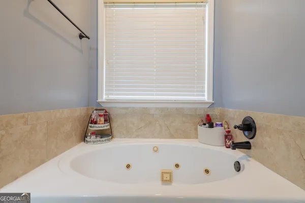 a bathroom with a tub and a window