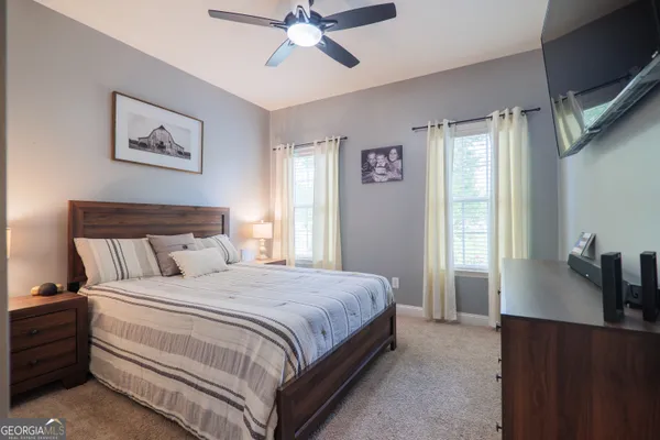 a bedroom with a bed and a chandelier
