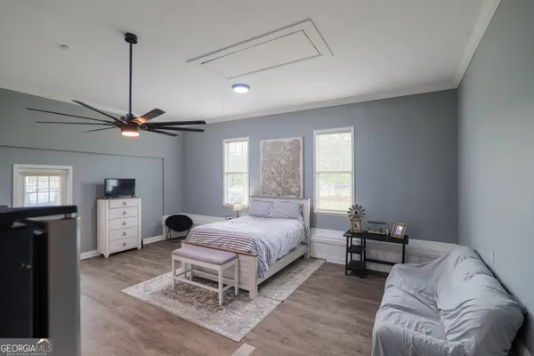 a bedroom with a bed window and couch