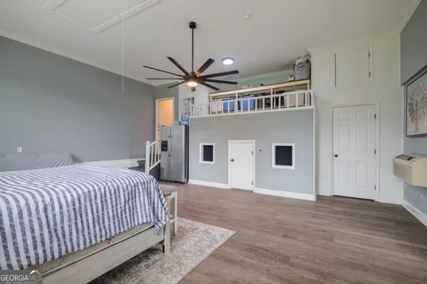 a bed room with a bed and a ceiling fan