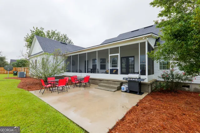 a view of a house with backyard and sitting area