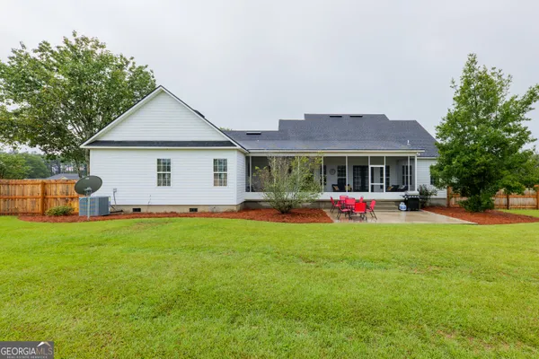 a front view of house with yard and trees