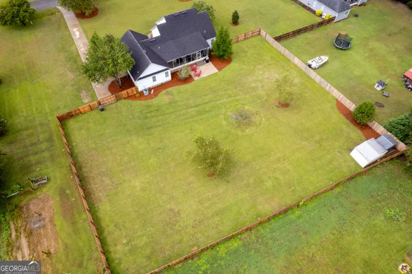 an aerial view of residential house with pool and yard