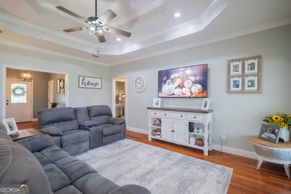 a living room with furniture and a flat screen tv