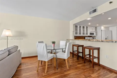 a view of kitchen with cabinets and wooden floor