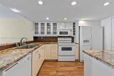 a kitchen with a sink stove and refrigerator