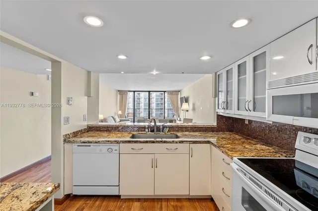 a kitchen with a sink stove and cabinets