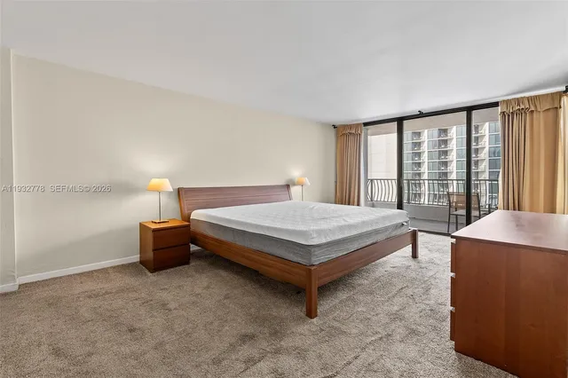 a bedroom with a bed and a night stand