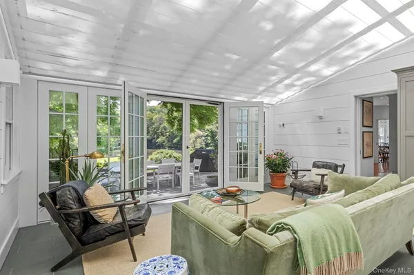 a living room with furniture and a floor to ceiling window