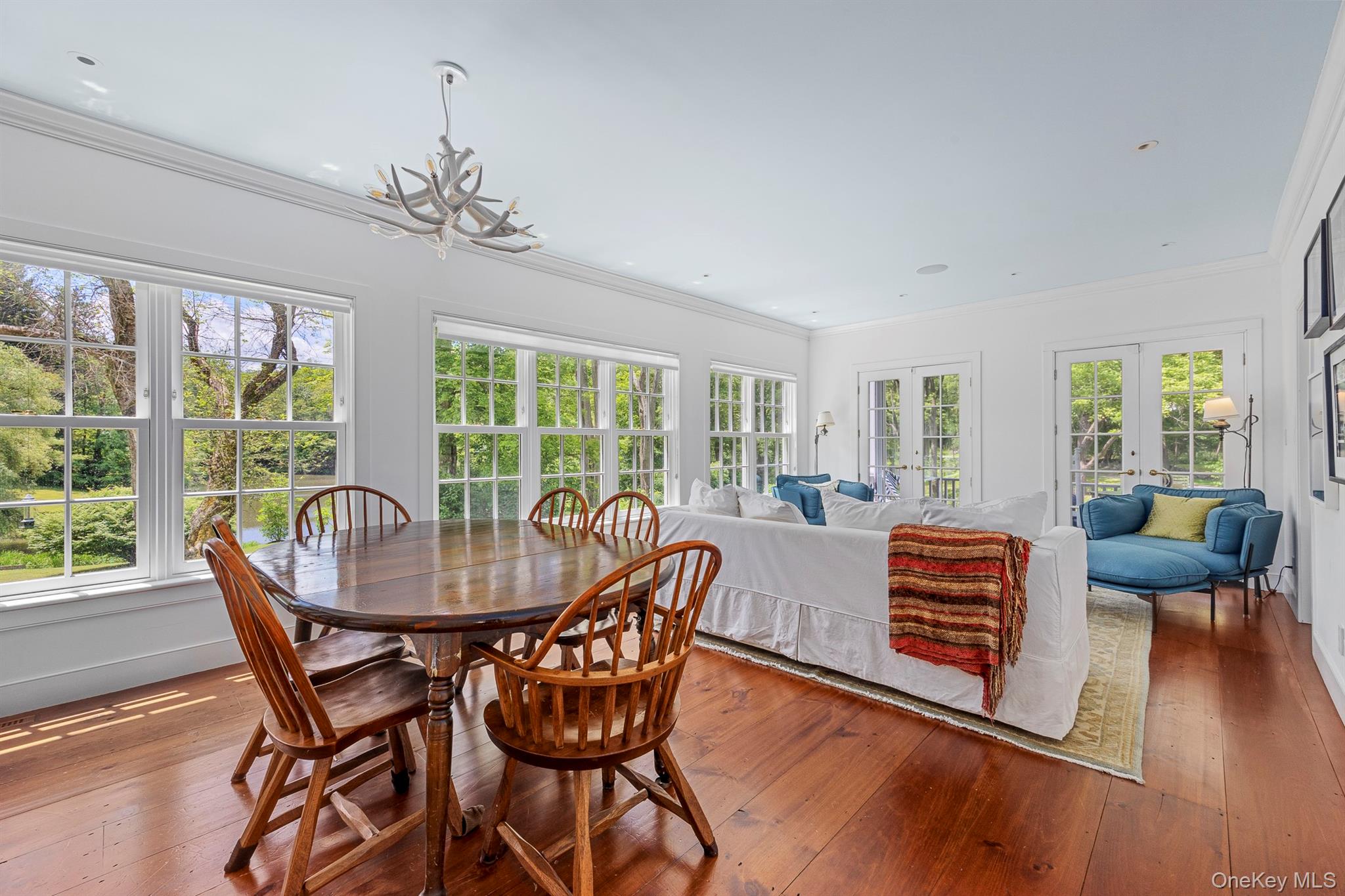 176 Schoolhouse Road Staatsburg, NY 12580 - Photo 19 of 37 a dining room with furniture a chandelier and wooden floor