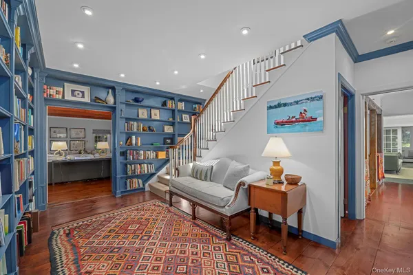 a living room with furniture and a book shelf