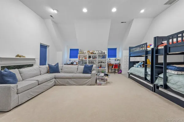 a living room with furniture and a ceiling fan