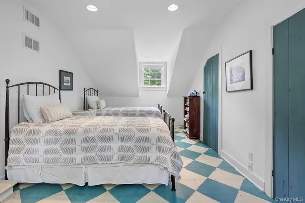 a bedroom with a bed and a view of walk in closet