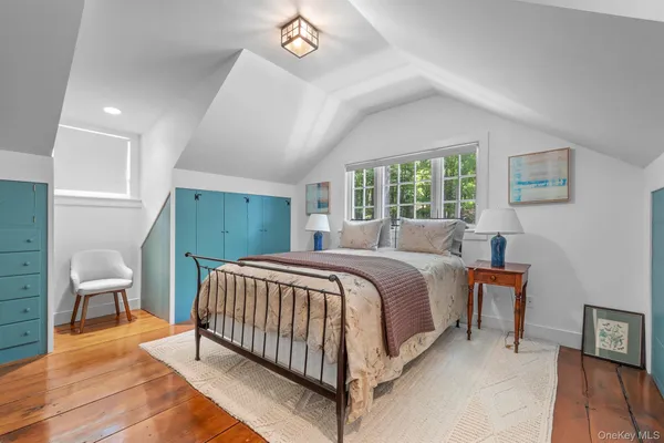 a bedroom with a bed and chair