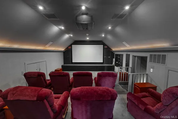 a media room with lots of chairs and a projector