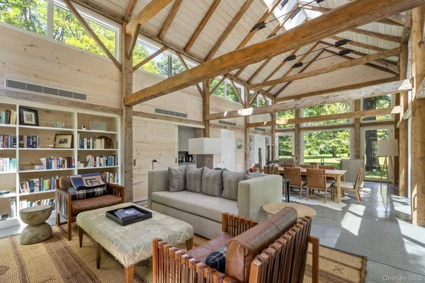 a living room with furniture and a floor to ceiling window