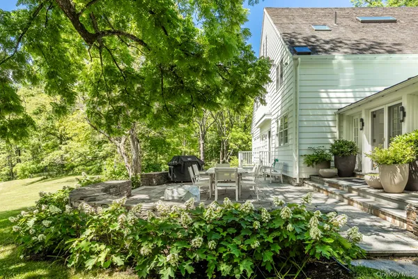 a backyard of a house with table and chairs