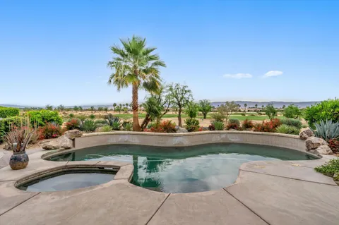 a view of a swimming pool and lounge chair