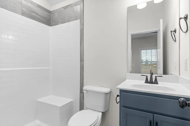 a bathroom with a sink toilet and mirror