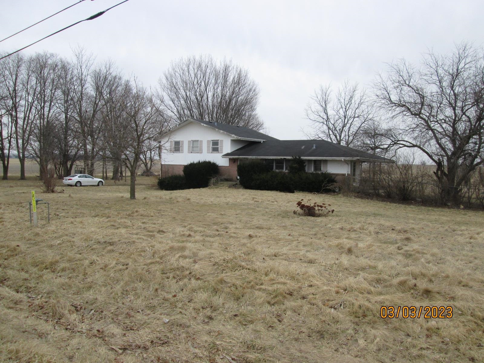 11408 Cunningham Road Winnebago, IL 61088 - Photo 8 of 31 a front view of a house with a yard and covered with snow