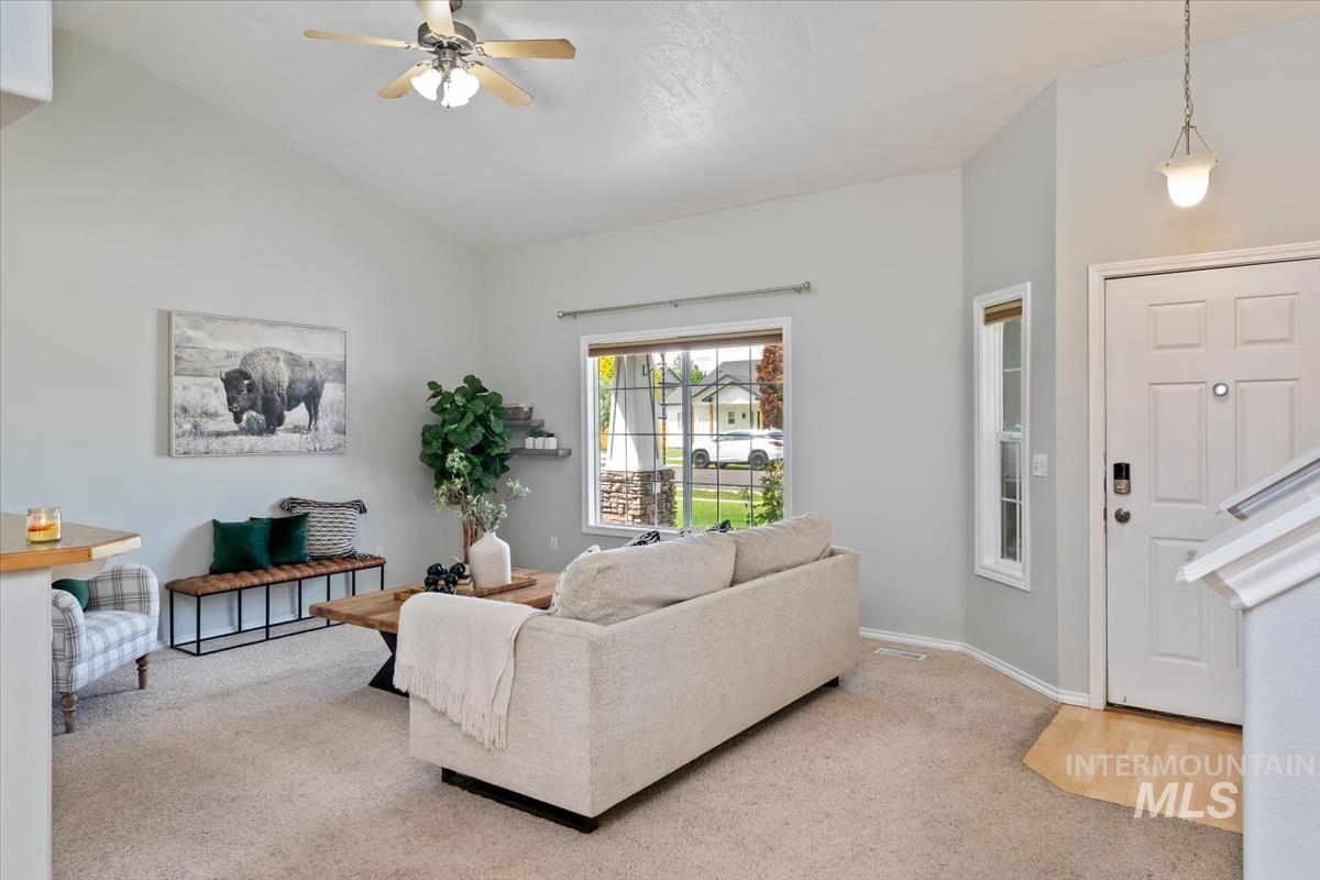 80 Cobblestone Court Middleton, ID 83644 - Photo 3 of 48 Living area featuring vaulted ceilings, a ceiling fan with integrated lighting, and carpet flooring