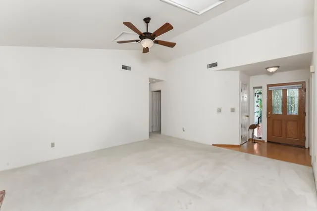 an empty room with closet and windows