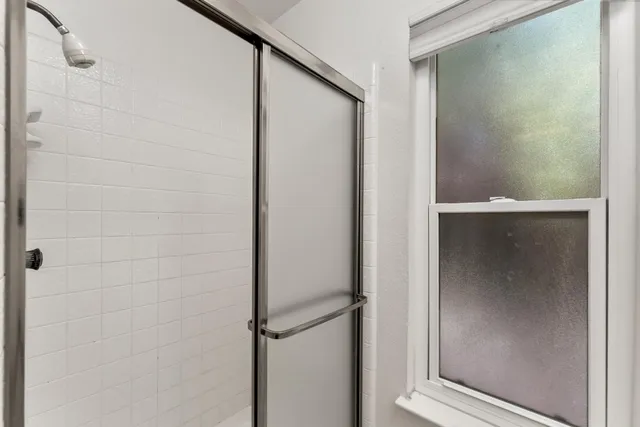 a bathroom with a glass shower door