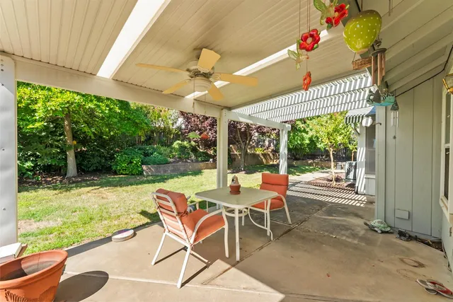 a view of a patio with a table chairs and a table