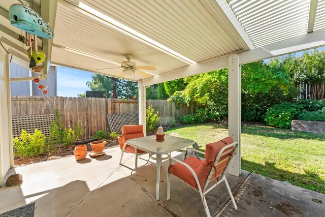 a view of backyard with swimming pool and outdoor seating