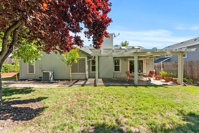 a view of a house with swimming pool and sitting area