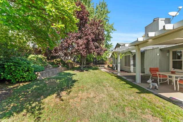 a view of a patio with table and chairs and potted plants
