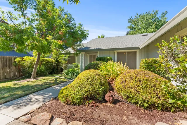 a front view of a house with garden