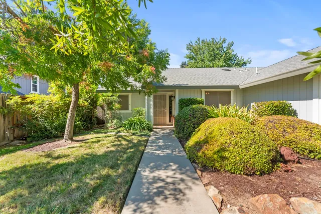 a front view of a house with garden