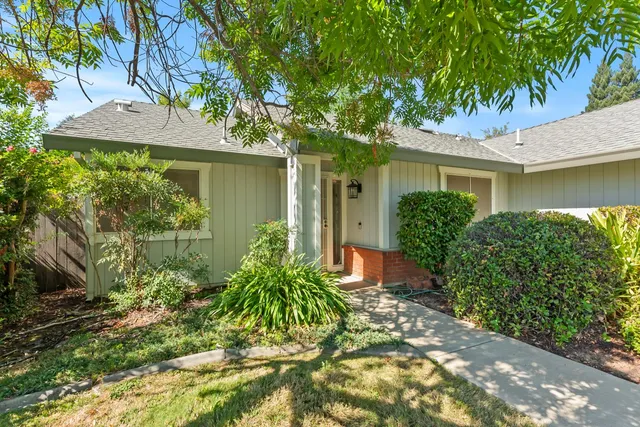 a front view of a house with garden
