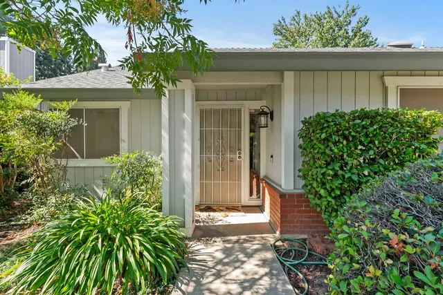 front view of a house with potted plants