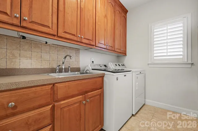 a kitchen with stainless steel appliances granite countertop a sink cabinets and a window