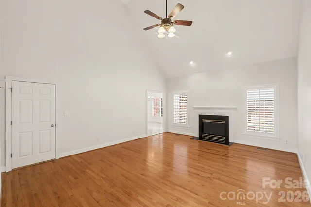 a view of empty room with a fireplace and fan